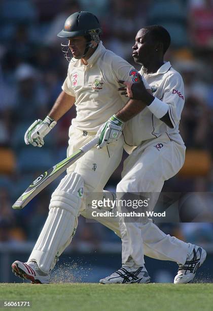 Fidel Edwards of the West Indies collides with Ricky Ponting of Australia as he runs between wickets during day one of the 1st Test between Australia...