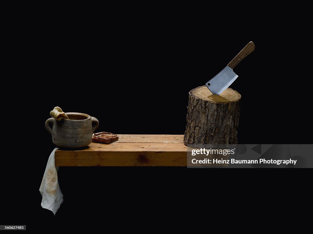 Cleaver, bone and mousetrap on black background.