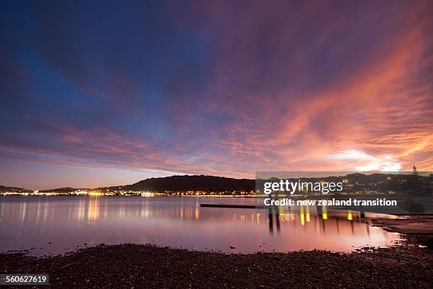 pink sunset over porirua harbour - wellington new zealand 個照片及圖片檔