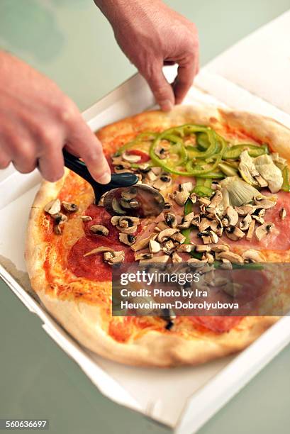 cutting pizza quattro stagioni - stagioni stock pictures, royalty-free photos & images