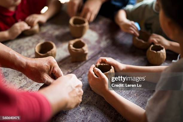 kids making cups with pottery clay - pottery making stock pictures, royalty-free photos & images