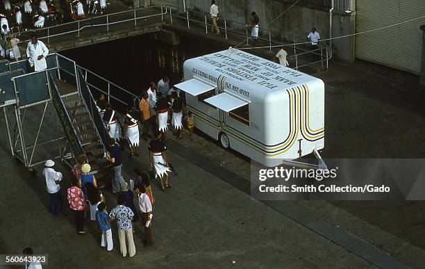 Mobile office of the Fiji Post Office and Fiji Visitors Bureau greeting American tourists disembarking from a cruise ship, the Fiji Islands, Republic...