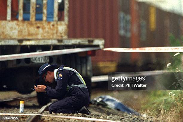 Police officer at the scene where a young women was killed in a fatal train collision with a car near the main road through Kumeu.Three children in...