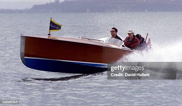 Spectators on board a classic reproduction speedboat, Misty head for port after sailing was cancelled on the seventh day of racing in the Loius...