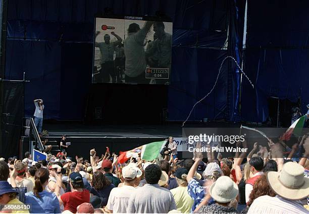 Crowds gather to watch the final race of the Louis Vuitton Cup on the big screen at the America's Cup Village during Pradas ninth race against...