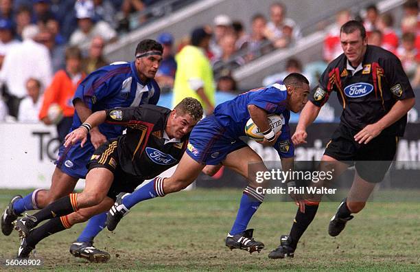 Auckland Blues Orene Ai'i under pressure from Waikato Chiefs Glen Marsh during their Super 12 match played at the North Harbour Stadium,Sunday.The...