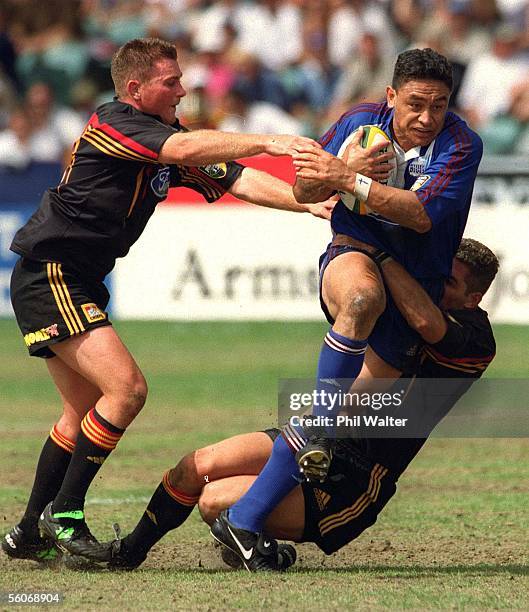 Auckland Blues Eroni Clarke is tackled by Waikato Chiefs Glen Marsh and Glen Jackson during their Super 12 match played at the North Harbour...