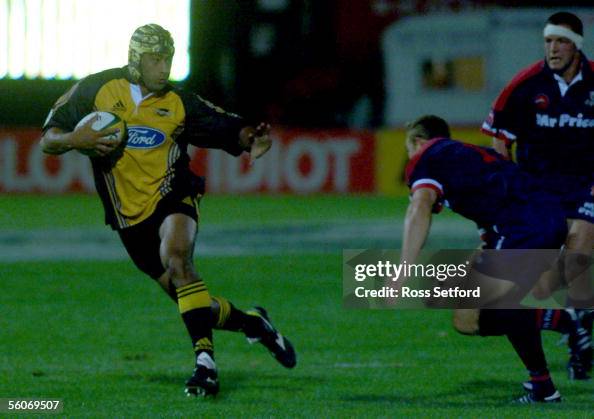 Inoke Raco Hurricanes Inoke Afeaki prepares to fend off the Cats Dean Hall in ...
