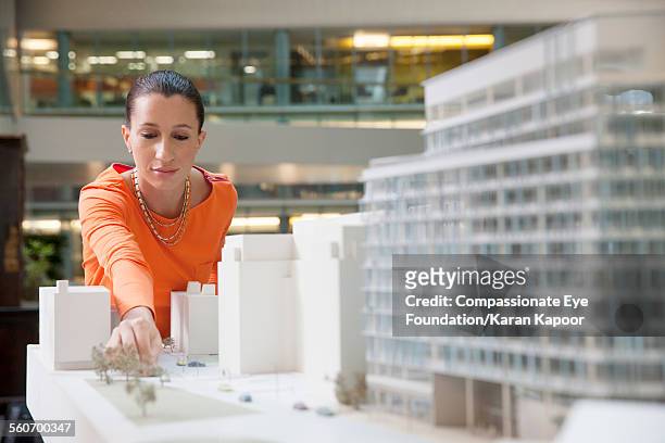 businesswoman looking at model building - architectural model stock pictures, royalty-free photos & images