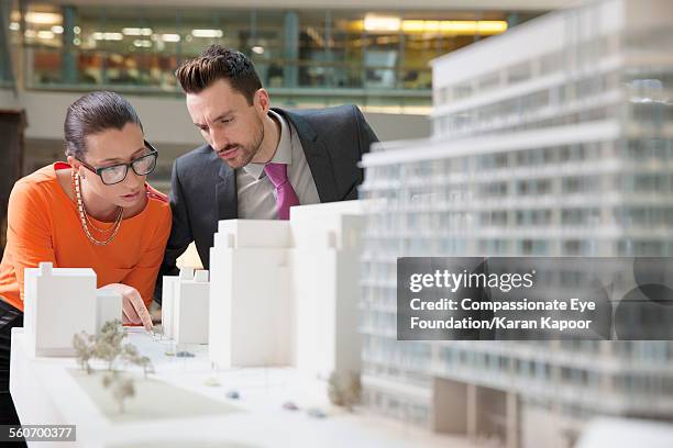 business people looking at model building - architectural model stock pictures, royalty-free photos & images