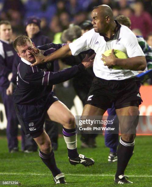 All Black Jonah Lomu plants his hand in the face of Scotland's Cameron Murray in the 2nd Philips International test played at Eden Park,Saturday.