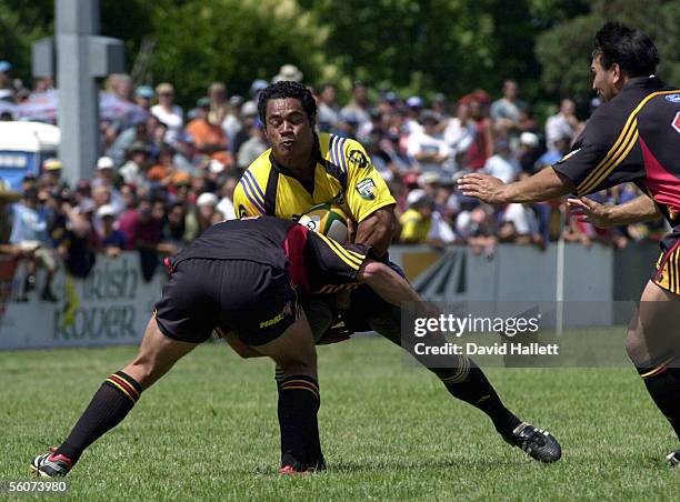 Hurricanes Inoke Afeaki tries to go through a tackle from a Chiefs defender during their pre season Super 12 rugby game, Saturday.