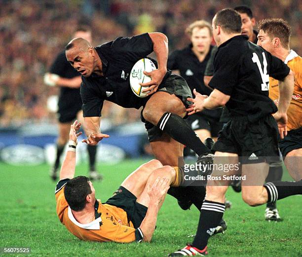 All Black Jonah Lomu charges over Wallaby Daniel Herbert in the Bledisloe Cup match at Stadium Australia, Sydney, Saturday. The Wallabies won 287.