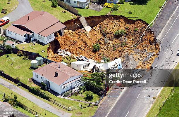 House in Barry Road, near the Martha Gold Mining company offices, collapsed into a huge hole measuring 50 metres wide and 15 metres deep, in the...