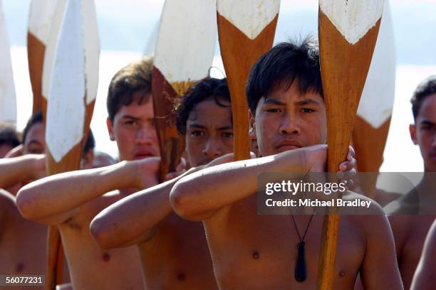 Some of the crew of the Waka hold their paddles ready as the wait for the start of the Church service held on the National Marae on Waitangi Day,...