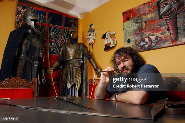 Peter Jackson, New Zealand director of The Lord of the Rings trilogy poses with the props from the film set in his Wingnut Films office in Wellington...