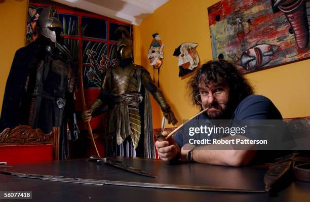 Peter Jackson, New Zealand director of The Lord of the Rings trilogy poses with the props from the fil set in his Wingnut Films office in Wellington...