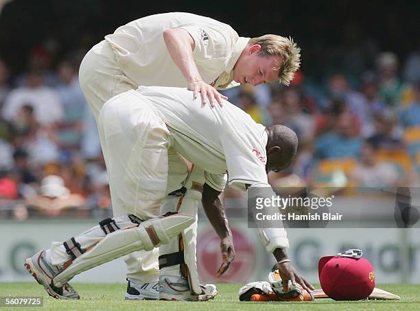 Brett Lee of Australia checks on Devon Smith of the West Indies after he was struck by a delivery from Lee during day two of the First Test between...