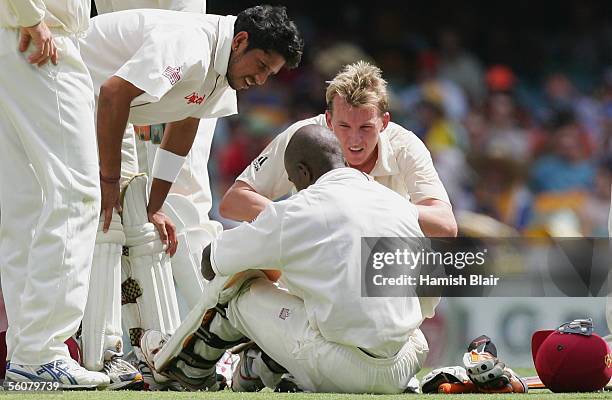 Ramnaresh Sarwan of the West Indies and Brett Lee of Australia check on Devon Smith of the West Indies after he was struck by a delivery from Lee...