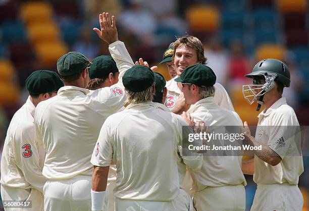 Glenn McGrath of Australia celebrates with team mates after taking the wicket of Chris Gayle of the West Indies during day two of the 1st Test...