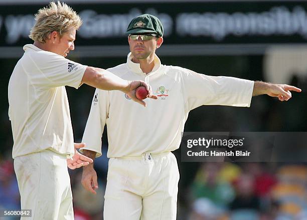 Shane Warne and Ricky Ponting of Australia talk tactics during day two of the First Test between Australia and the West Indies played at the Gabba on...