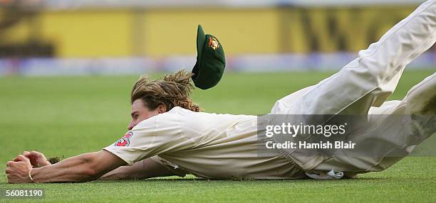 Nathan Bracken of Australia dives to catch Shivnarine Chanderpaul of the West Indies during day two of the First Test between Australia and the West...