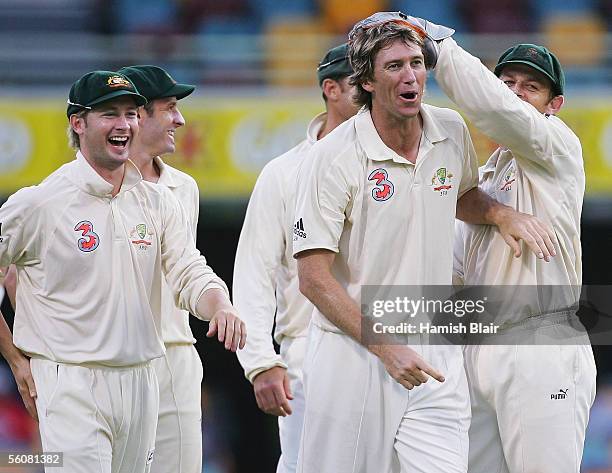 Glenn McGrath of Australia celebrates with team mates after taking the wicket Devon Smith of the West Indies during day two of the First Test between...