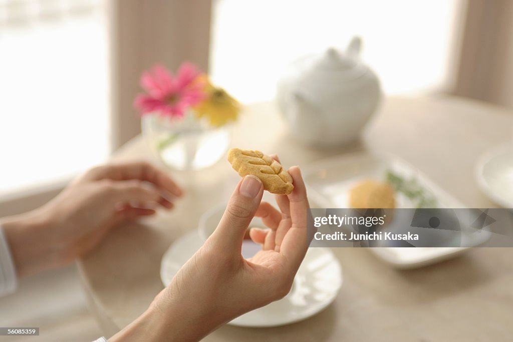 Close-up of a young woman's hand holding cookie