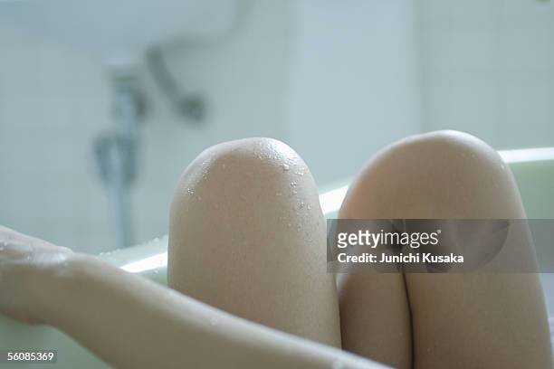 close-up of a young woman's legs in bathtub - japanese women bath stock pictures, royalty-free photos & images