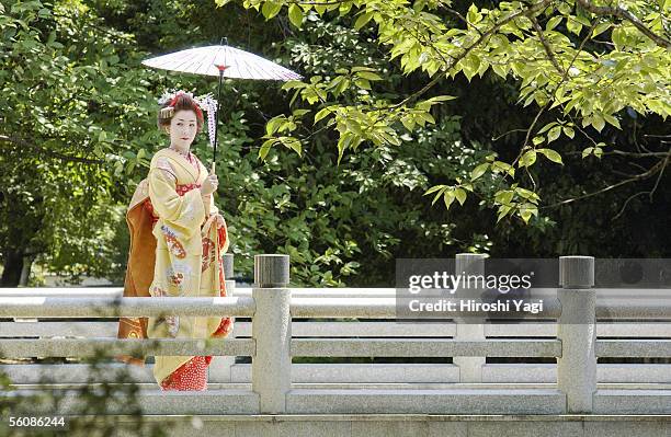 portrait of a geisha  woman holding umbrella - geisha ストックフォトと画像