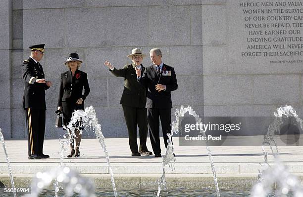 Prince Charles, Prince of Wales and Camilla, Duchess of Cornwall are given a tour of the World War II Memorial by Major General Guy Swan III and...
