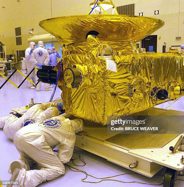 Engineers from Johns Hopkins University check out NASA's New Horizons spacecraft 04 November 2005 in the Payload Hazardous Servicing Facility at...