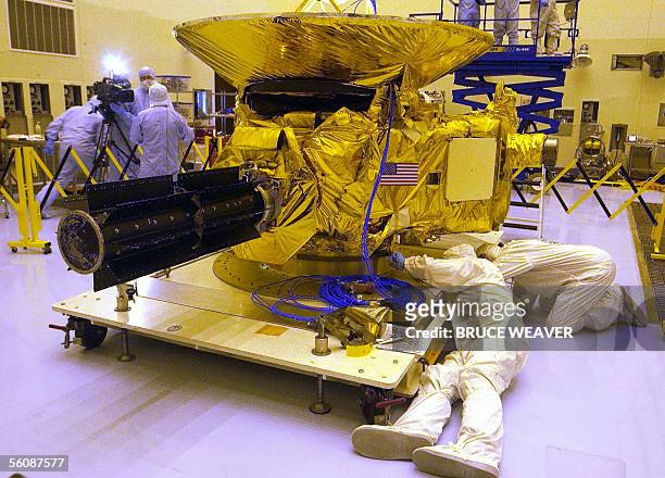 Engineers from Johns Hopkins University check out NASA's New Horizons spacecraft 04 November 2005 in the Payload Hazardous Servicing Facility at...