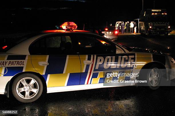 As night falls the Armed Offenders squad assess the situation at the road block at Taipo Road in the rural Manuwatu township of Rongotea after an...