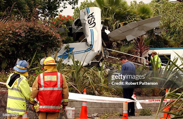 Rescue services attend to a two seater Piper Tomahawk which crashed into a garden in Tennis Court Road, Raumati, Kapiti Coast, at 1pm killing the...
