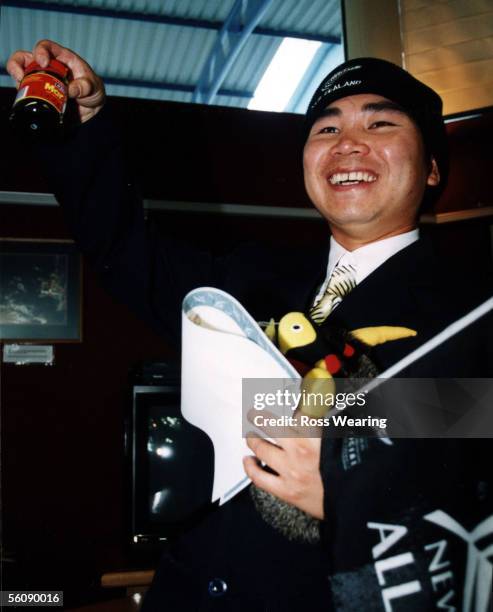 New Zealand's long awaited Four Millionth Citizen Ngoc Kim Nguyen proudly displays 'Kiwi Icons' Marmite and a Buzzy Bee after he received his New...