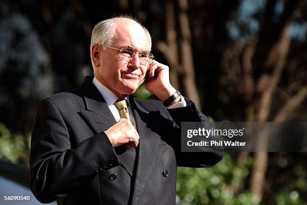 Australian Prime Minister John Howard makes a phonecall in the carpark of the Sheraton after the Pacific Islands Forum held inside was evactuated...