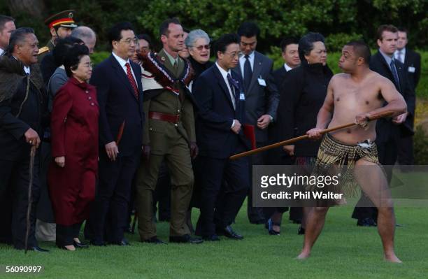 President of the People's Republic of China Hu Jintao and Madame Liu Yongqing follow a traditional challenge from Maori Petty Officer Robert Hewitt...