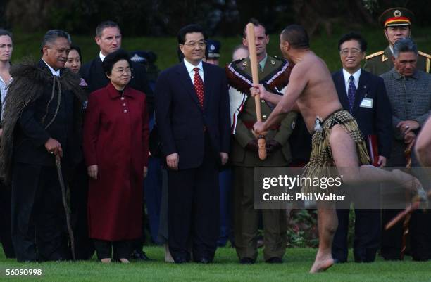 President of the People's Republic of China Hu Jintao and Madame Liu Yongqing accept a Maori traditional challenge from Petty Officer Robert Hewitt...