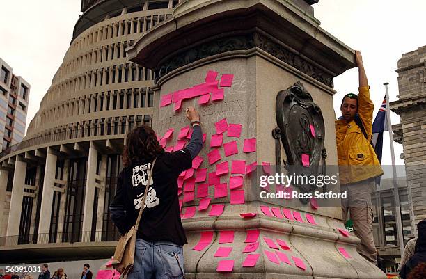 Protesters leave "postit" notes on the Richard Seddon monument outside Parliament, Wellington, Saturday after a march through the city.