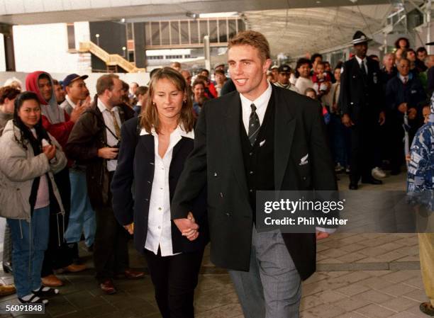 Justin Marshall and girlfriend Bernadine OliverKerby leave Auckland Airport after arriving home from the All Blacks tour to South Africa.