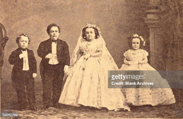 American circus performer Charles Sherwood Stratton, aka 'General Tom Thumb,' poses with his new bride Mercy Lavinia Warren Bump and their wedding...