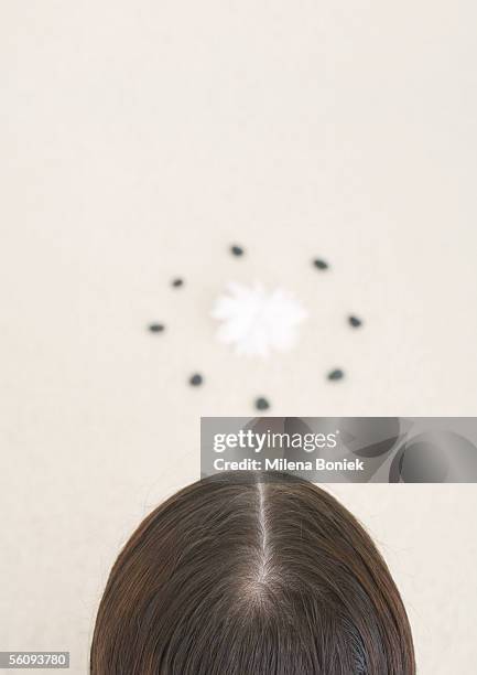 back of woman's head and flower inside circle - hair part stock-fotos und bilder