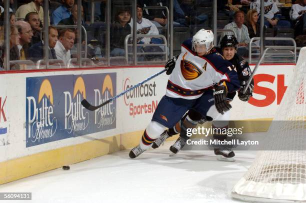 Peter Bondra of the Atlanta Thrashers skates behind the goal against Mike Green of the Washington Capitals during a game at MCI Center on November 4,...