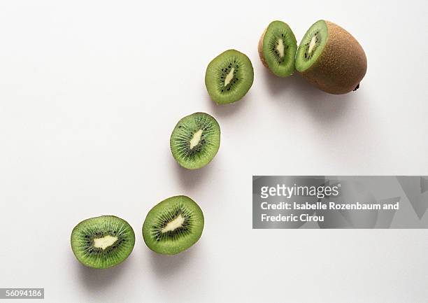 kiwi and kiwi slices - kiwi fruit stock pictures, royalty-free photos & images