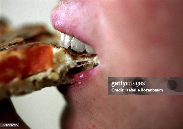 person eating, close up of mouth. - brot mund stock-fotos und bilder