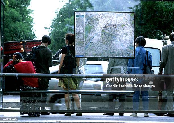 people standing at bus stop, rear view. - bus shelter ストックフォトと画像