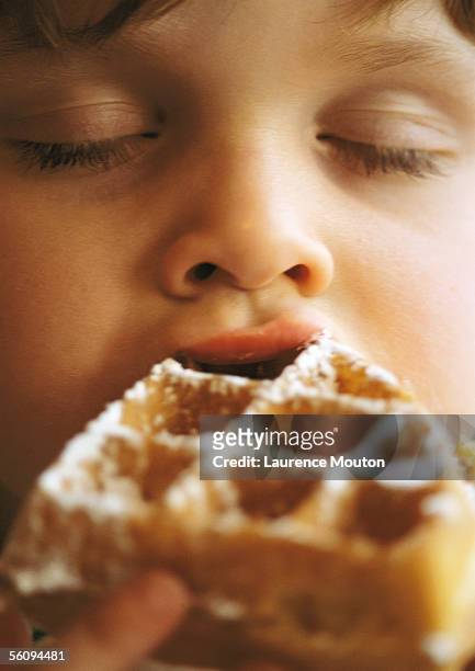 child eating waffle, close-up. - waffle stock-fotos und bilder