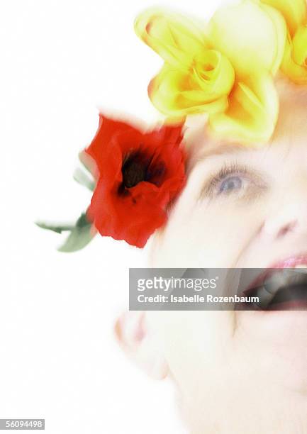 elderly woman with flowers on head, low angle view, blurred - adorno floral fotografías e imágenes de stock