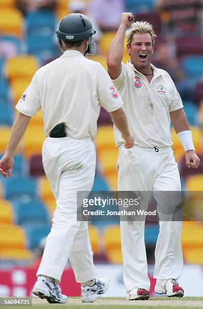 Shane Warne of Australia celebrates his fifth wicket of the innings during day three of the 1st Test between Australia and the West Indies at the...